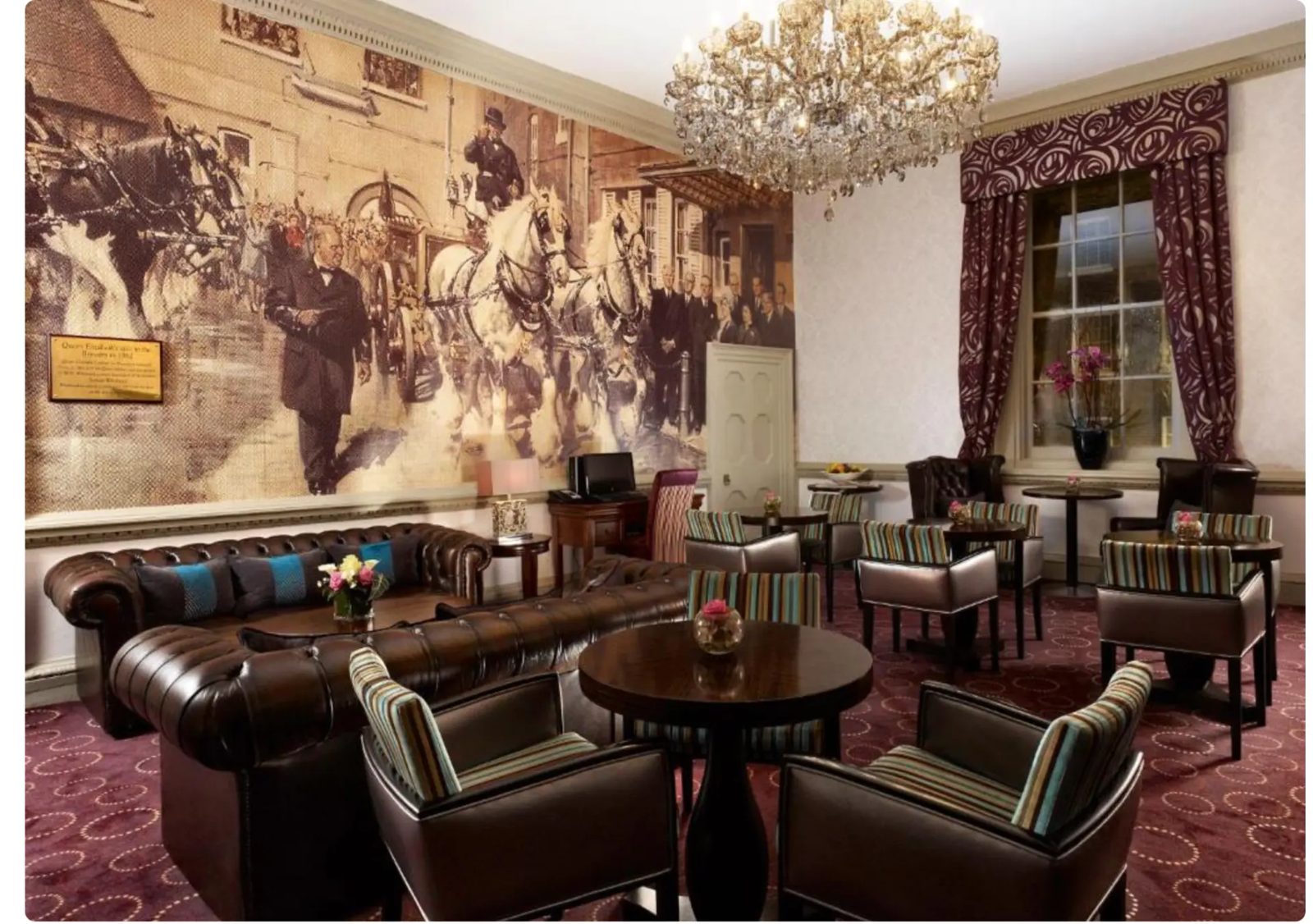 The Montcalm at The Brewery lounge with chandelier, chesterfield sofas and a heritage mural