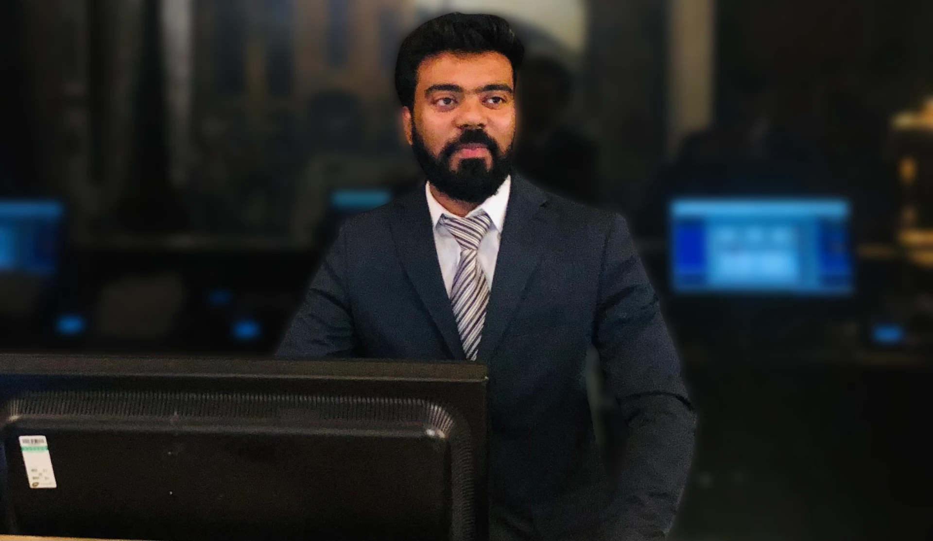 Kushagra Verma behind the front desk at The Montcalm at The Brewery in a professional suit
