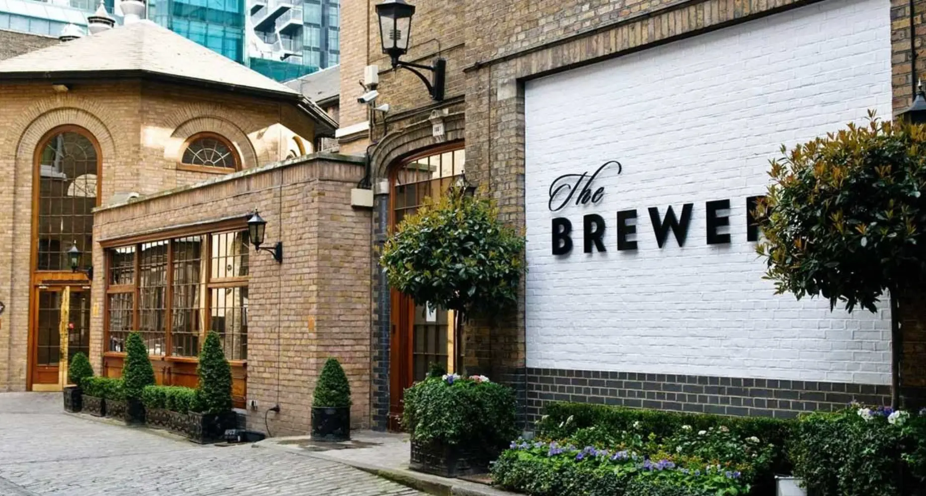 The Brewery courtyard in London City with heritage brickwork and signage
