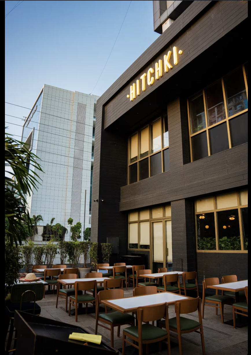 Exterior of Hitchki restaurant with illuminated signage and outdoor seating